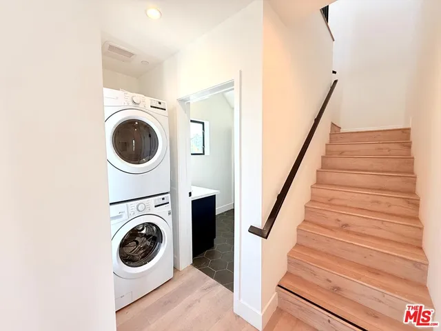 a view of an empty room with glass door and balcony