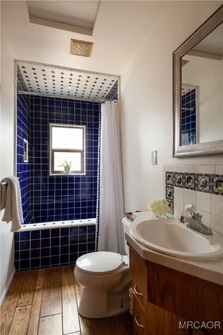 a bathroom with a sink toilet and mirror