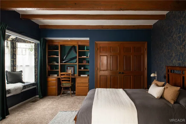 a bedroom with a bed and a window