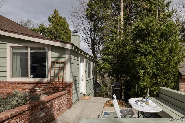 a view of a patio with table and chairs and potted plants