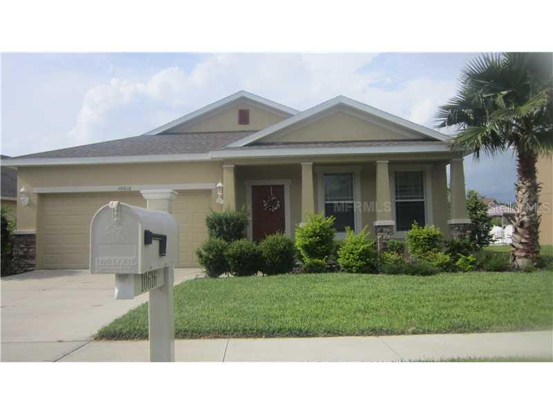 10616 Ribbon Fern Way Land O Lakes, FL 34638 - Photo 1 of 1 a front view of a house with a yard and potted plants
