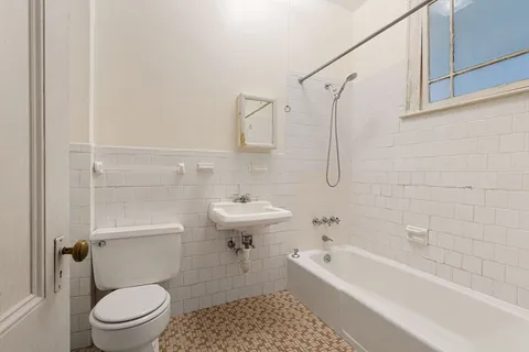 a bathroom with a sink a toilet and a bathtub