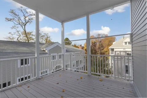 a view of a balcony with wooden floor