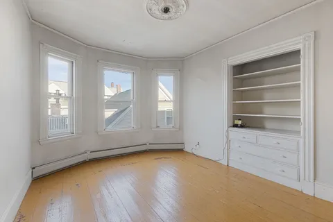 a view of room with window and hardwood floor