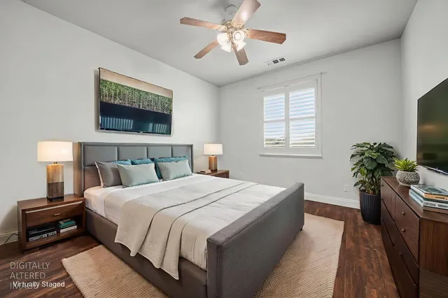 a bedroom with bed and a potted plant