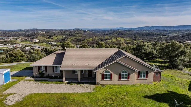an aerial view of residential house and sandy dunes
