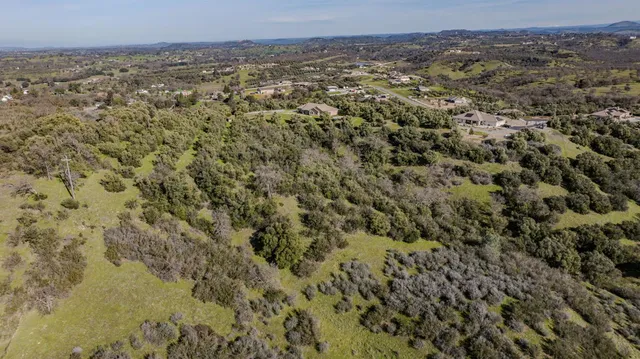 an aerial view of residential house and mountain view