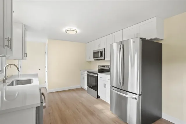 a kitchen with a refrigerator sink and microwave