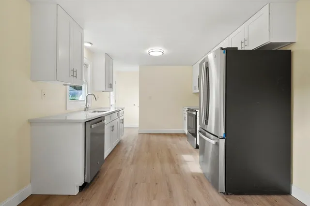 a kitchen with a refrigerator and a sink