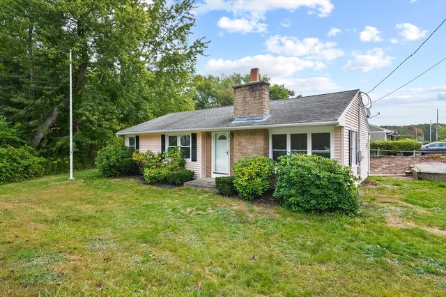 a front view of a house with garden