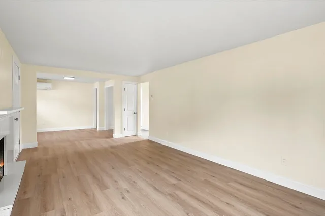 a view of an empty room and wooden floor