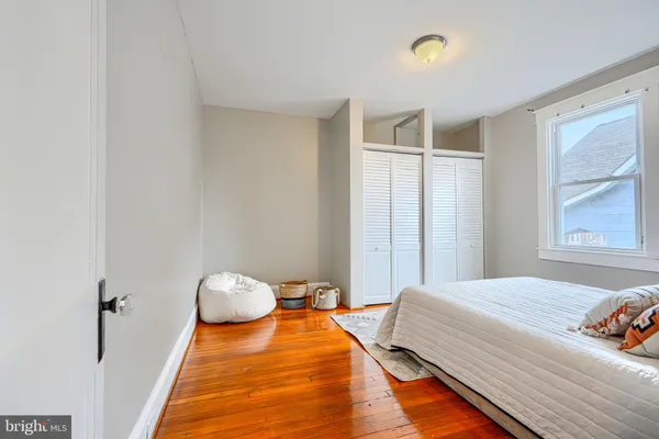 a room with wooden floor and a window