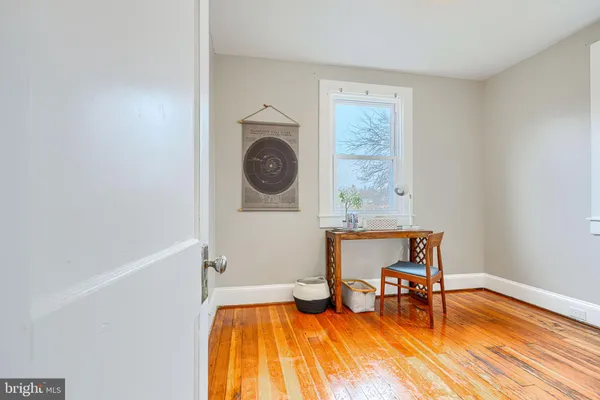 a view of a storage room with refrigerator and windows