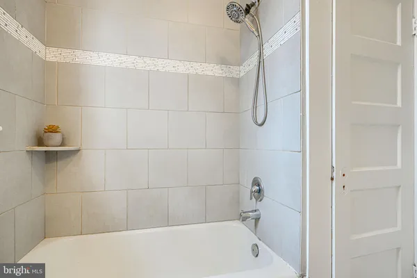 a view of empty room with a window and wooden floor