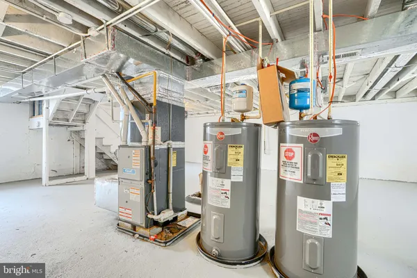 a kitchen with granite countertop stainless steel appliances a refrigerator a sink a stove top oven and a refrigerator