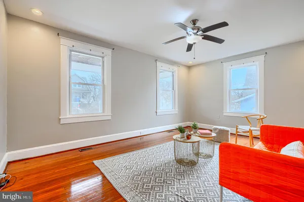 a view of empty room with wooden floor and furniture