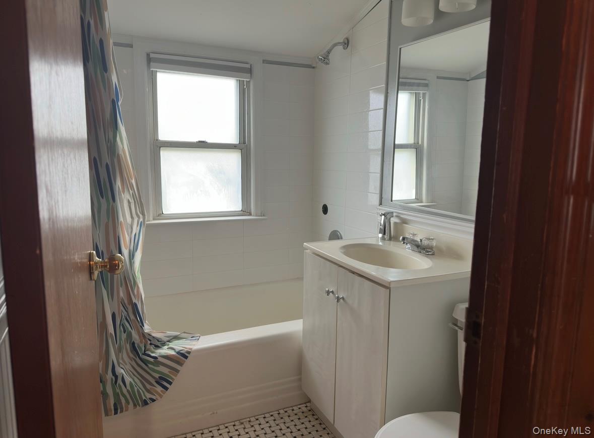 484 Chelsea Road Oceanside, NY 11572 - Photo 13 of 23 Bathroom featuring shower / tub combo and vanity