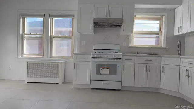 a kitchen with cabinets appliances and a window
