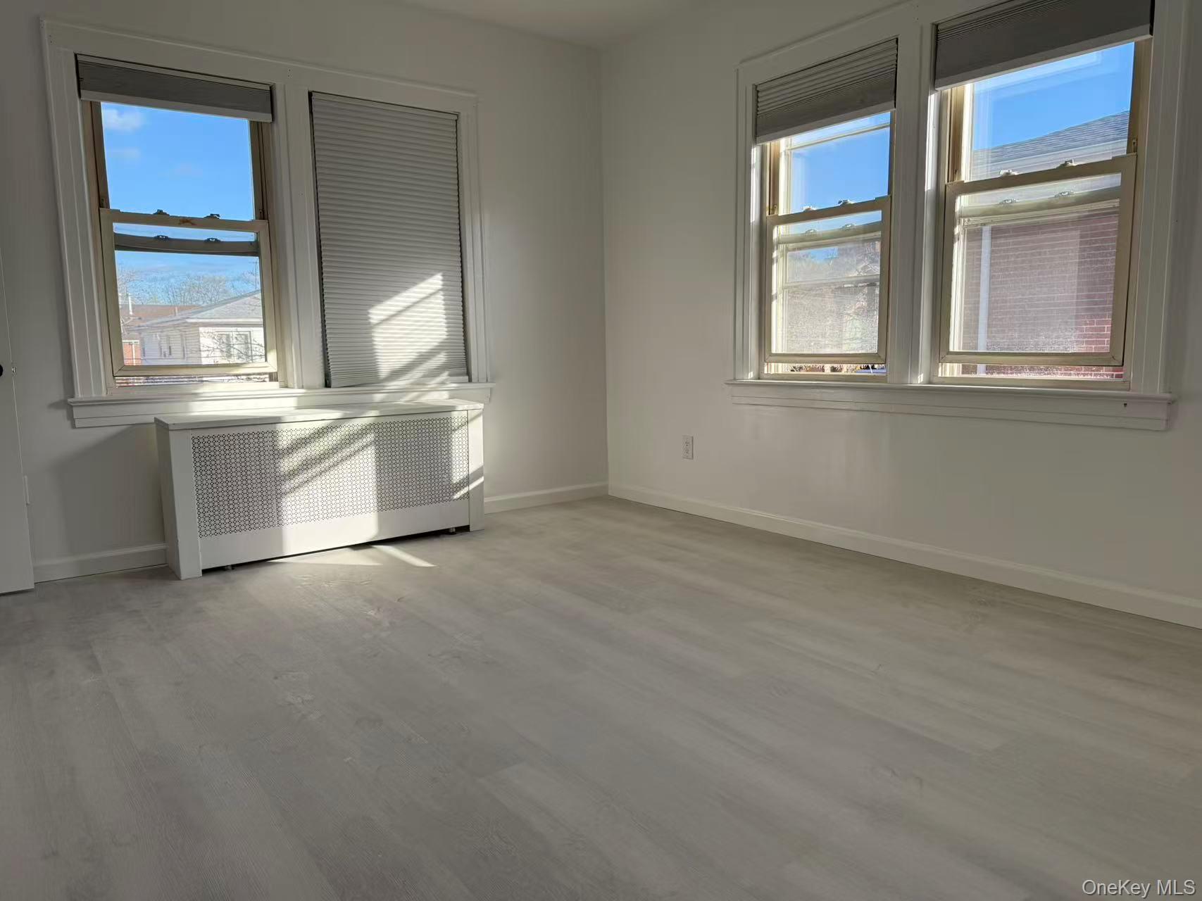 40-14 190th Street, Unit 2 Queens, NY 11358 - Photo 3 of 6 an empty room with windows