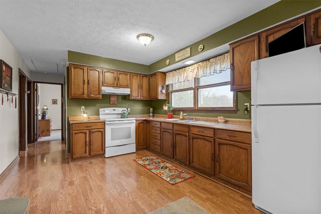 173 Amsterdam Road Grove City, PA 16127 - Photo 11 of 25 a kitchen with stainless steel appliances granite countertop a refrigerator sink and wooden cabinets