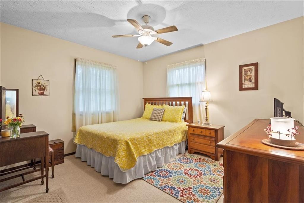 173 Amsterdam Road Grove City, PA 16127 - Photo 12 of 25 a bedroom with a bed and a table in it