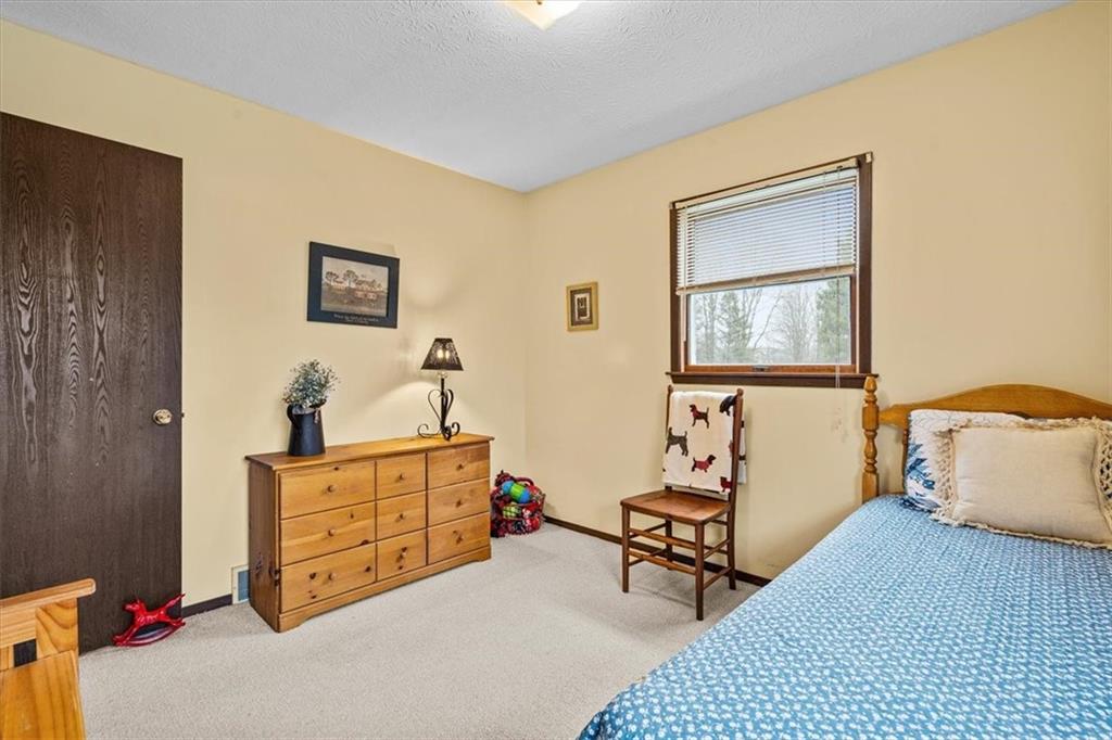 173 Amsterdam Road Grove City, PA 16127 - Photo 16 of 25 a bedroom with furniture and a window