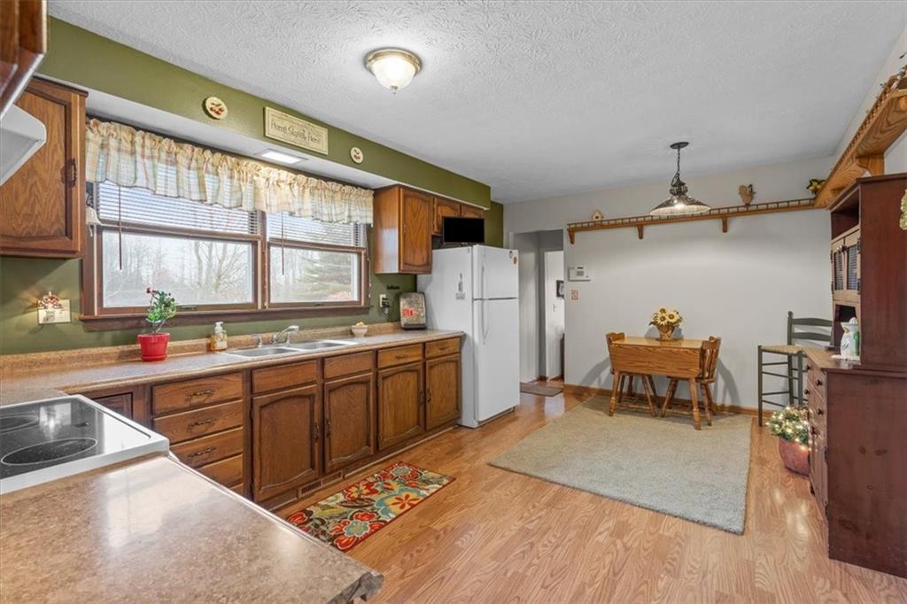 173 Amsterdam Road Grove City, PA 16127 - Photo 9 of 25 a kitchen with refrigerator a sink and cabinets