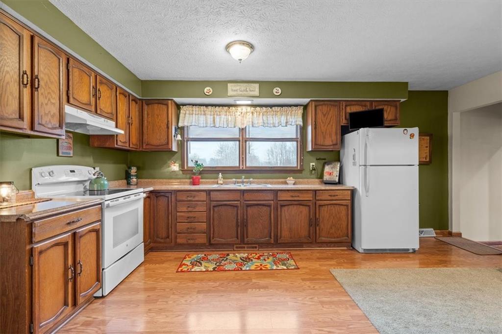 173 Amsterdam Road Grove City, PA 16127 - Photo 10 of 25 a kitchen with a refrigerator and a sink