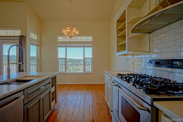 a kitchen with wooden floors and a stove