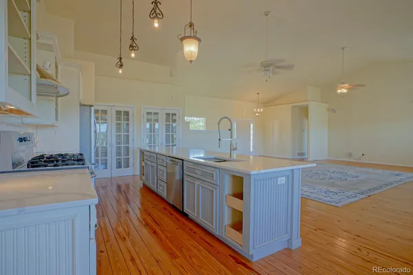 a kitchen with stainless steel appliances a stove top oven and cabinets