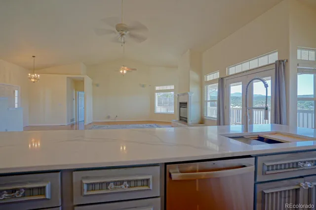 a view of kitchen with granite countertop a sink and a counter top space