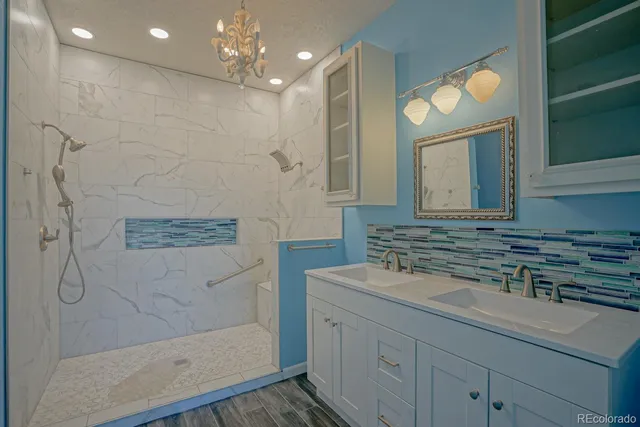 a bathroom with a sink a vanity a mirror and a shower