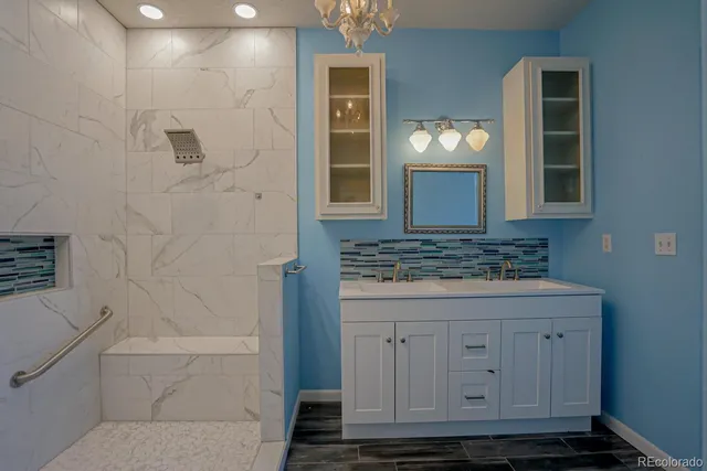 a bathroom with a granite countertop sink a toilet and mirror