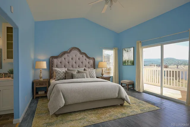 a bedroom with a large bed and a large window