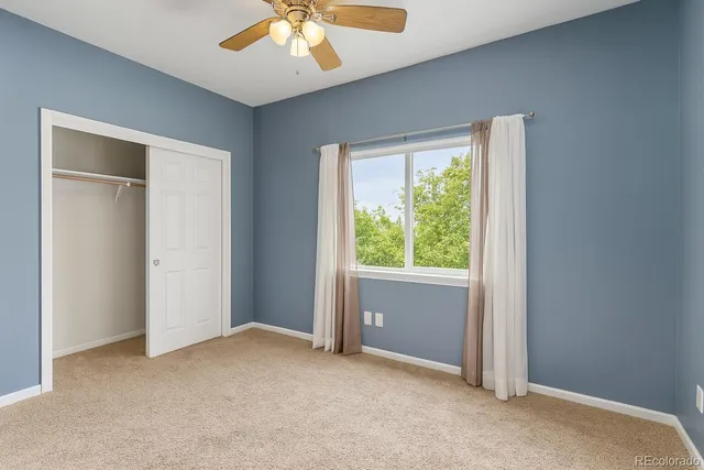 an empty room with windows and closet