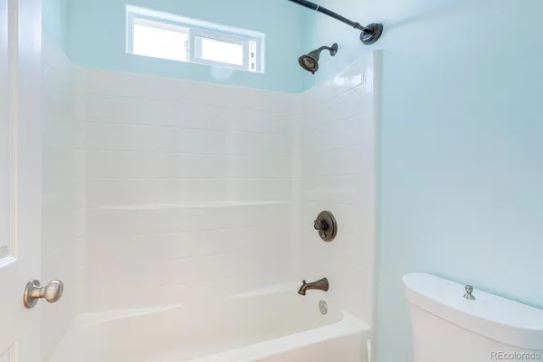 a bathroom with a shower and a toilet
