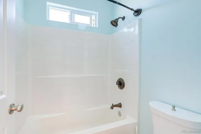 a bathroom with a shower and a toilet