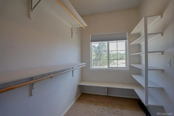 a view of room with window and a ceiling fan
