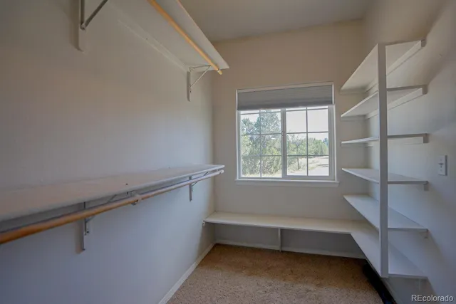 a view of room with window and a ceiling fan