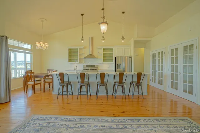 an open kitchen with granite countertop a view of living room and kitchen view