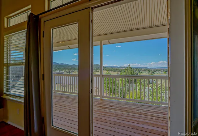 a view of a balcony next to a yard