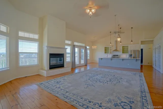 a view of an empty room with a fireplace and window