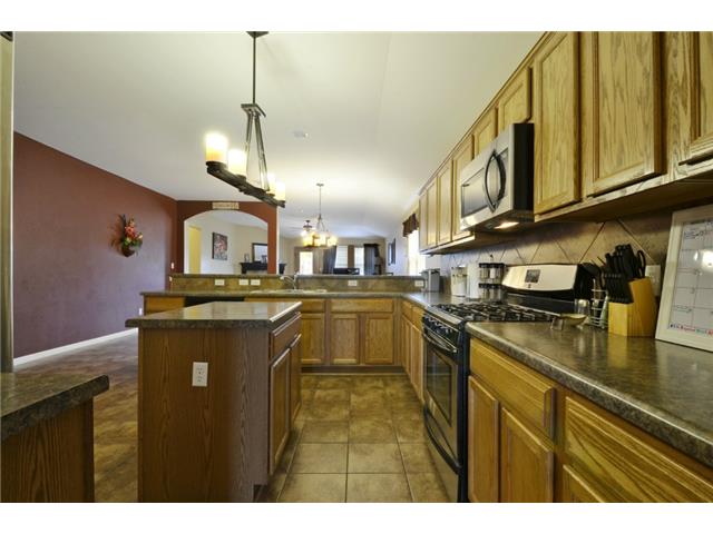 11612 Timber Heights Drive Austin, TX 78754 - Photo 9 of 28 Prepare meals in this kitchen featuring abundant wood cabinetry and modern appliances.