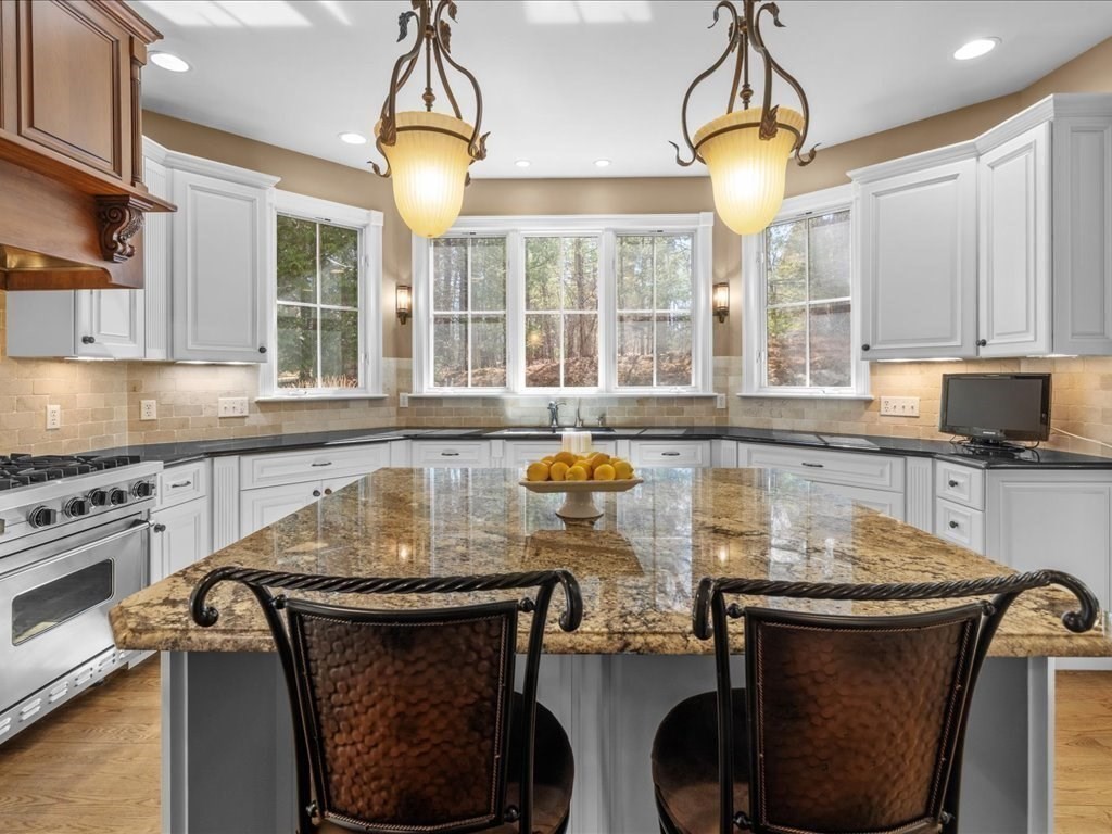 2 Copperbeech Circle Westborough, MA 01581 - Photo 12 of 42 a kitchen with a stove and a chandelier