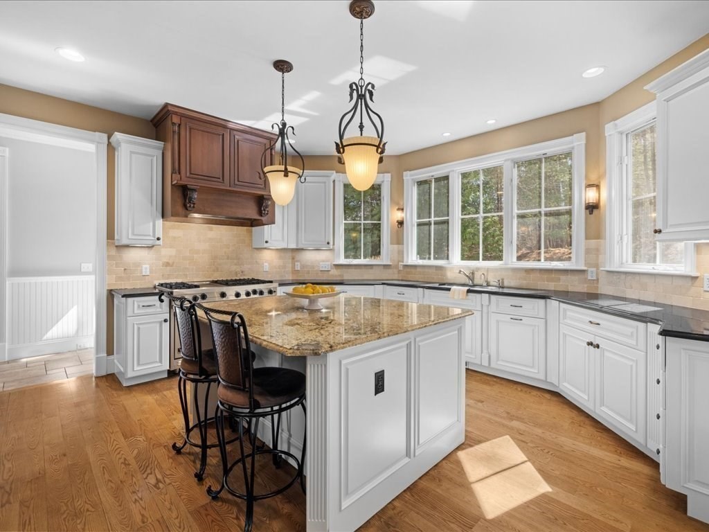 2 Copperbeech Circle Westborough, MA 01581 - Photo 13 of 42 a kitchen with stainless steel appliances granite countertop wooden floor a stove a sink dishwasher and cabinets with wooden floor