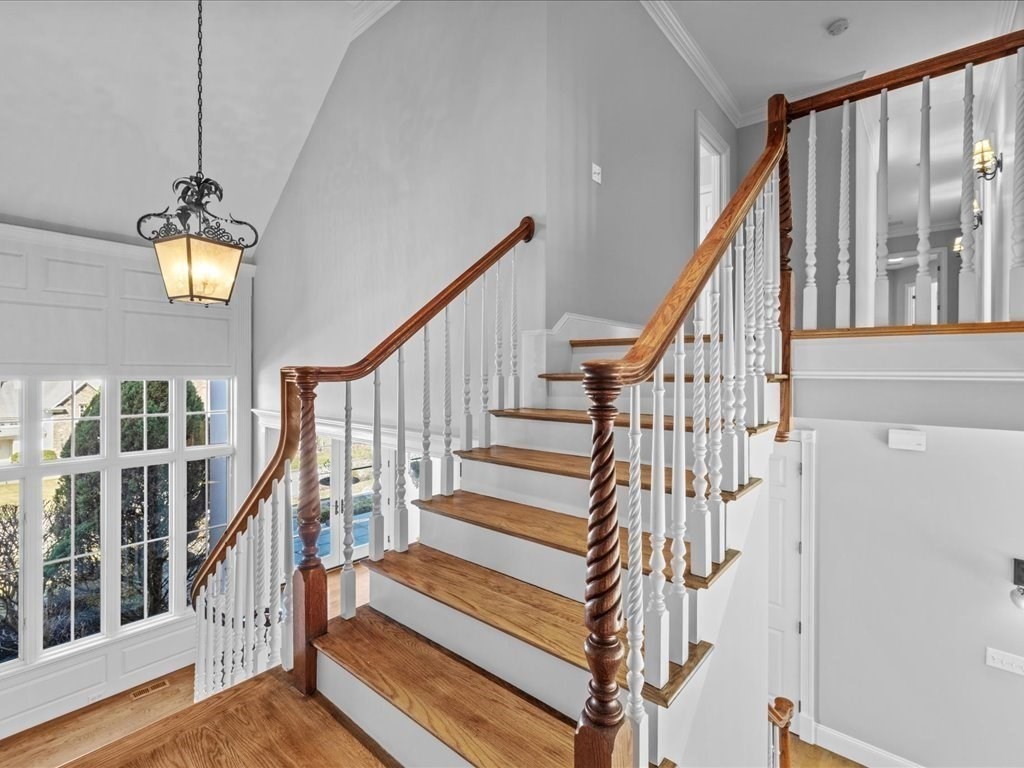 2 Copperbeech Circle Westborough, MA 01581 - Photo 21 of 42 a view of staircase with railing and a chandelier
