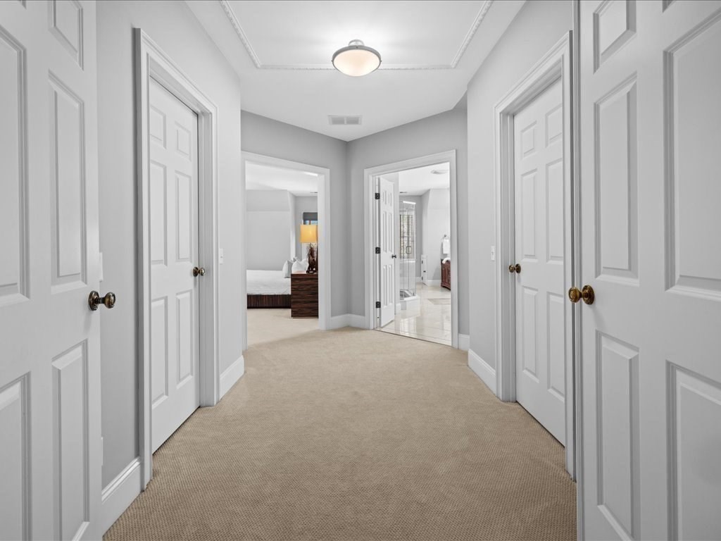2 Copperbeech Circle Westborough, MA 01581 - Photo 31 of 42 a view of a hallway with wooden shelves