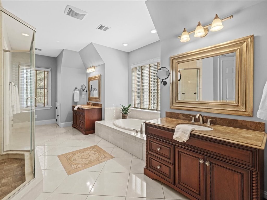 2 Copperbeech Circle Westborough, MA 01581 - Photo 34 of 42 a spacious bathroom with a double vanity sink a large mirror and a bathtub