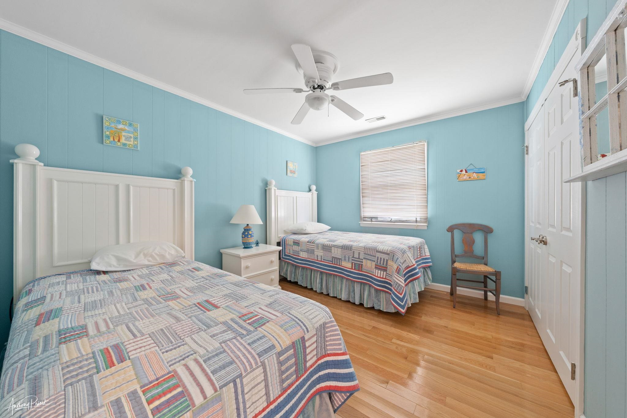 2968 First Avenue Avalon, NJ 08202 - Photo 16 of 23 a bedroom with a bed and a chandelier