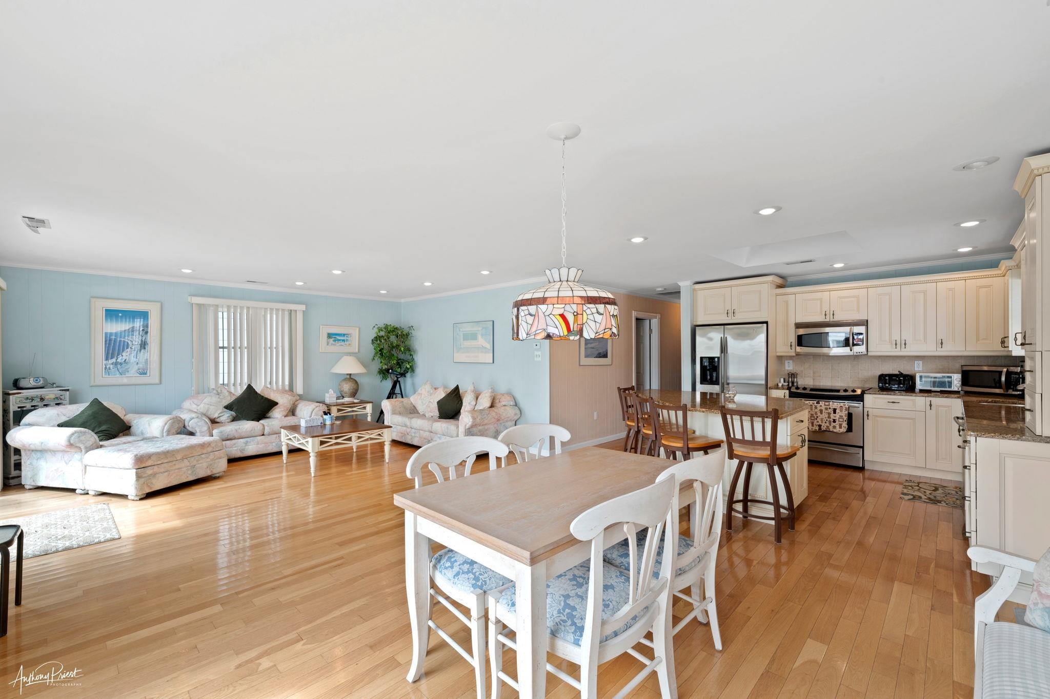 2968 First Avenue Avalon, NJ 08202 - Photo 4 of 23 a living room with furniture kitchen view and a wooden floor